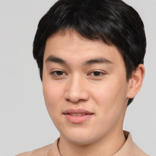 Joyful asian young-adult male with short  brown hair and brown eyes
