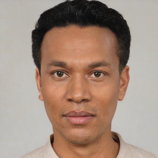 Joyful latino young-adult male with short  black hair and brown eyes