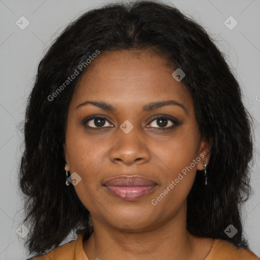 Joyful black young-adult female with long  brown hair and brown eyes