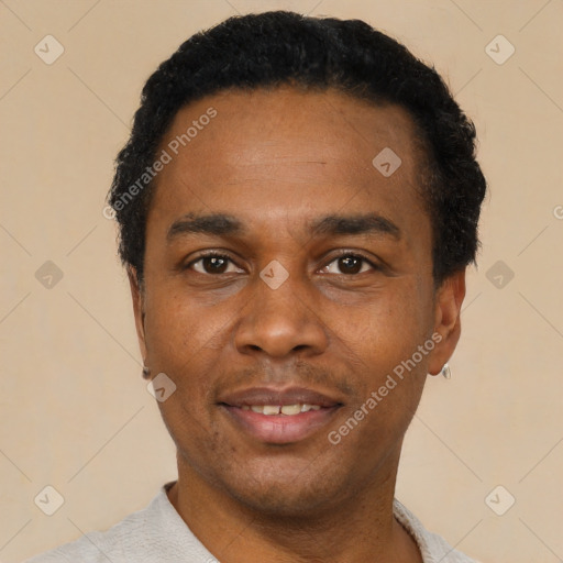 Joyful black young-adult male with short  black hair and brown eyes