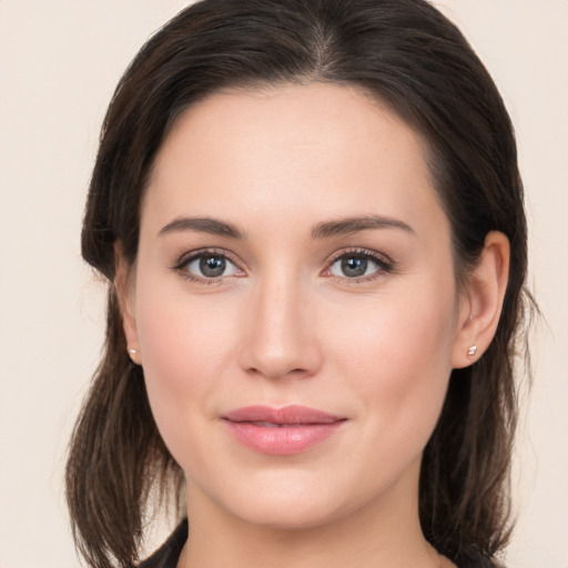 Joyful white young-adult female with medium  brown hair and brown eyes