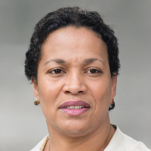 Joyful black adult female with short  brown hair and brown eyes