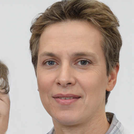 Joyful white adult female with short  brown hair and brown eyes