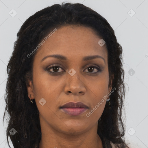 Joyful black adult female with long  brown hair and brown eyes