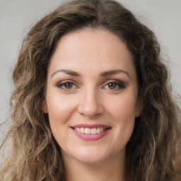 Joyful white young-adult female with long  brown hair and green eyes