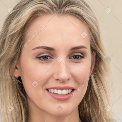 Joyful white young-adult female with long  brown hair and blue eyes