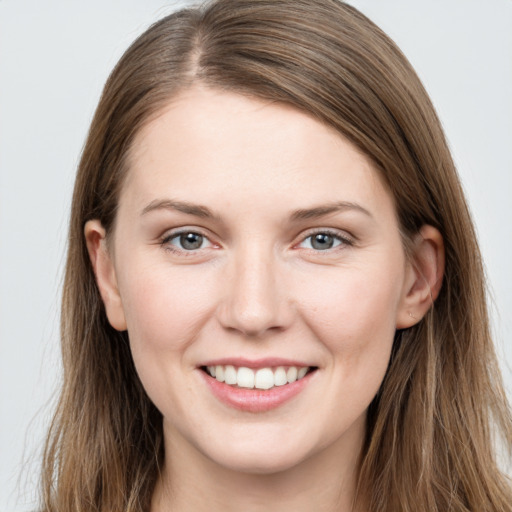 Joyful white young-adult female with long  brown hair and grey eyes