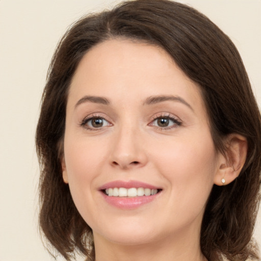 Joyful white young-adult female with medium  brown hair and brown eyes