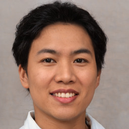 Joyful asian young-adult male with short  brown hair and brown eyes