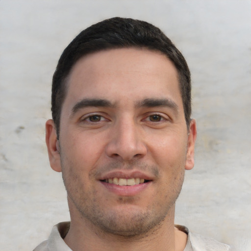 Joyful white young-adult male with short  brown hair and brown eyes