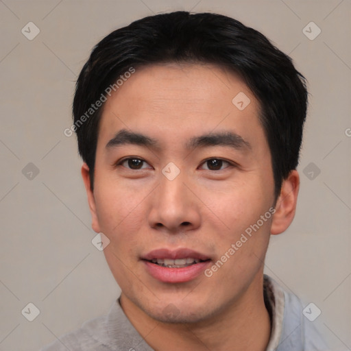 Joyful asian young-adult male with short  black hair and brown eyes