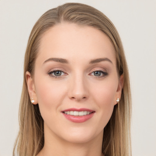 Joyful white young-adult female with long  brown hair and grey eyes