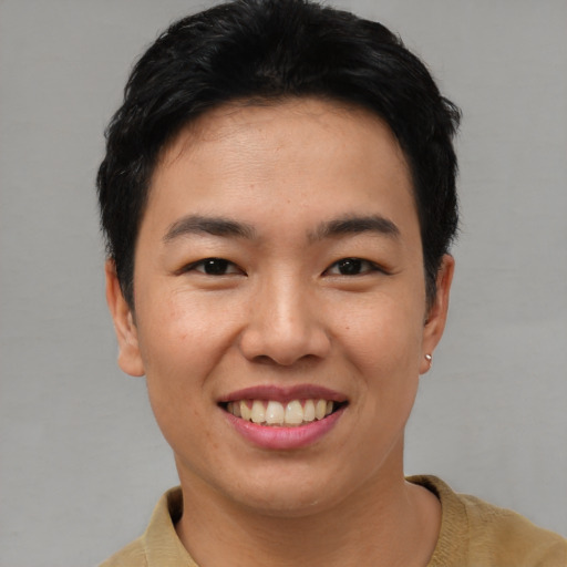Joyful asian young-adult male with short  brown hair and brown eyes