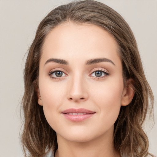 Joyful white young-adult female with medium  brown hair and green eyes