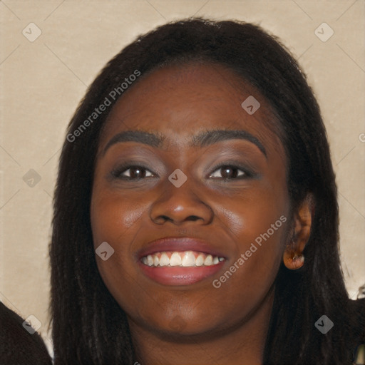 Joyful black young-adult female with long  black hair and brown eyes