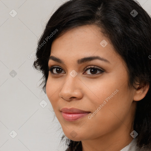 Joyful latino young-adult female with long  brown hair and brown eyes