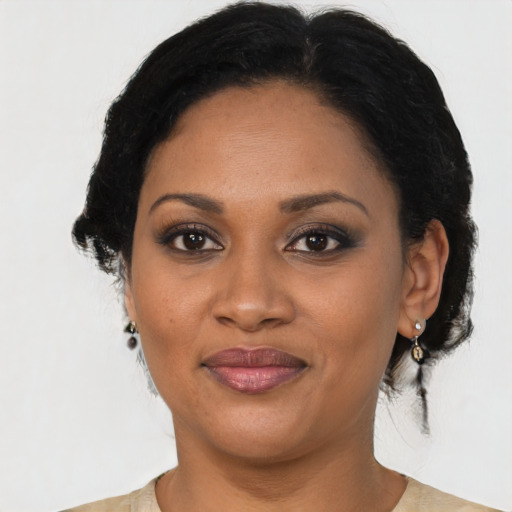 Joyful black adult female with medium  brown hair and brown eyes