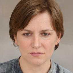 Joyful white young-adult female with medium  brown hair and blue eyes