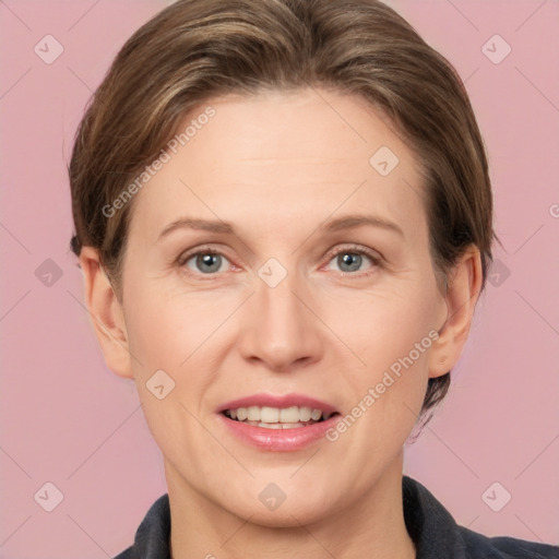 Joyful white adult female with medium  brown hair and grey eyes