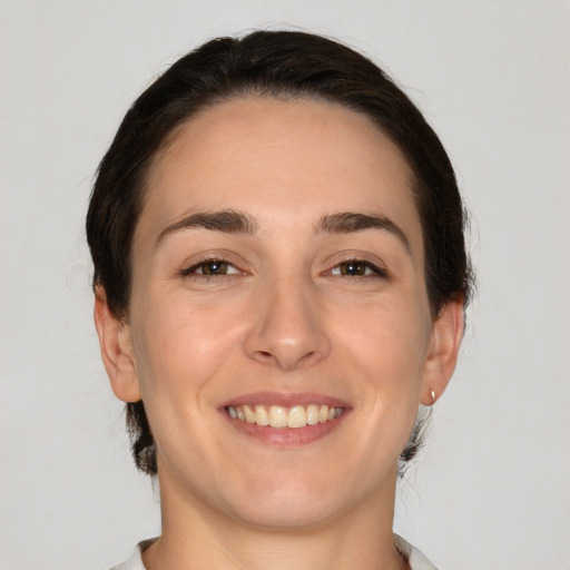 Joyful white young-adult female with medium  brown hair and brown eyes