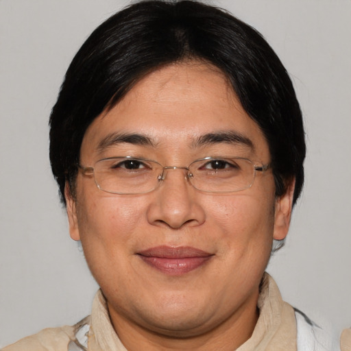 Joyful asian adult male with short  brown hair and brown eyes