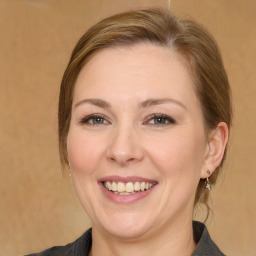 Joyful white young-adult female with medium  brown hair and grey eyes