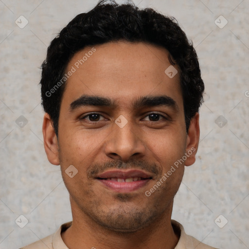 Joyful latino young-adult male with short  black hair and brown eyes