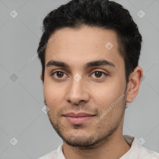 Joyful white young-adult male with short  black hair and brown eyes