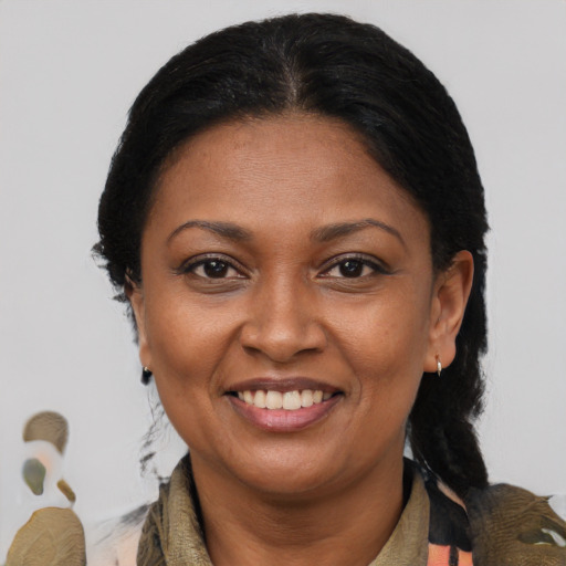 Joyful latino adult female with medium  brown hair and brown eyes