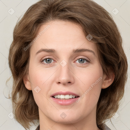 Joyful white young-adult female with medium  brown hair and green eyes