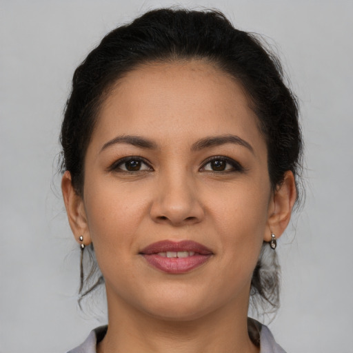 Joyful latino young-adult female with medium  brown hair and brown eyes