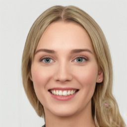 Joyful white young-adult female with long  brown hair and green eyes