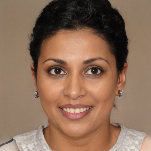 Joyful latino young-adult female with short  brown hair and brown eyes
