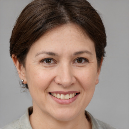 Joyful white adult female with medium  brown hair and brown eyes