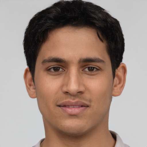 Joyful latino young-adult male with short  brown hair and brown eyes