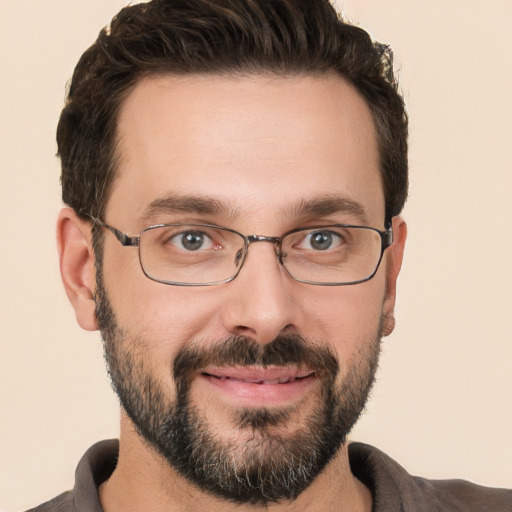 Joyful white adult male with short  brown hair and brown eyes