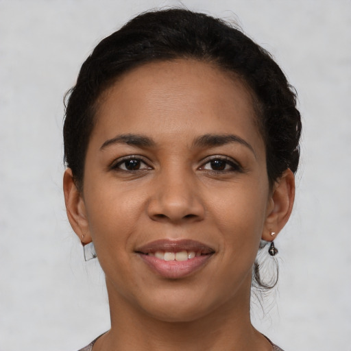 Joyful latino young-adult female with short  brown hair and brown eyes