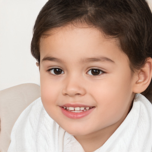 Joyful white child female with short  brown hair and brown eyes