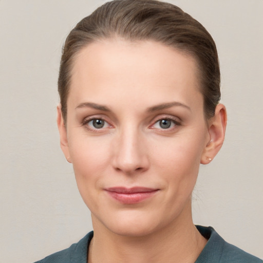 Joyful white young-adult female with short  brown hair and grey eyes