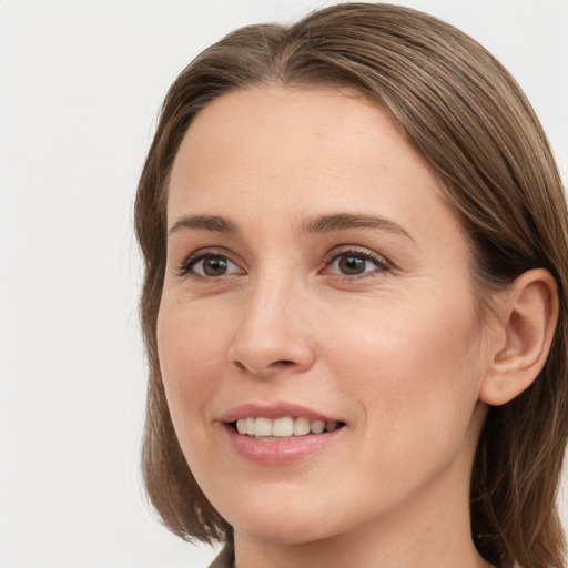 Joyful white young-adult female with medium  brown hair and grey eyes