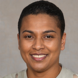 Joyful latino young-adult female with short  brown hair and brown eyes