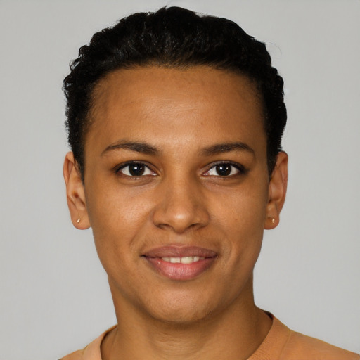 Joyful black young-adult female with short  black hair and brown eyes
