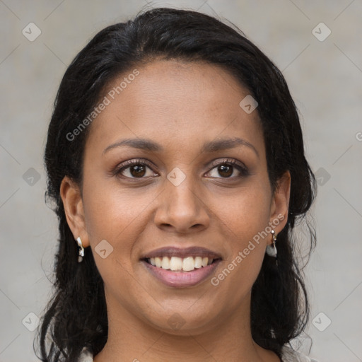 Joyful black young-adult female with long  brown hair and brown eyes