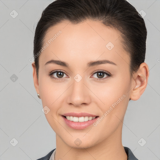 Joyful white young-adult female with short  brown hair and brown eyes