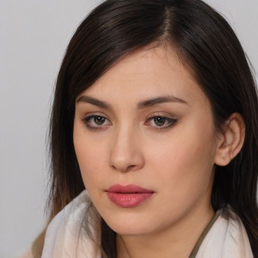 Joyful white young-adult female with long  brown hair and brown eyes