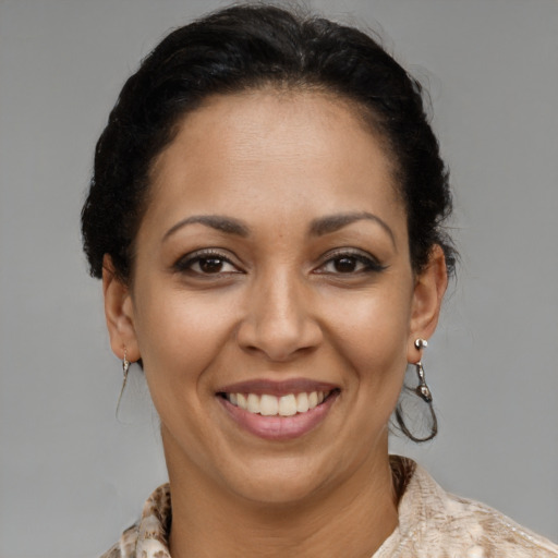 Joyful latino young-adult female with medium  brown hair and brown eyes