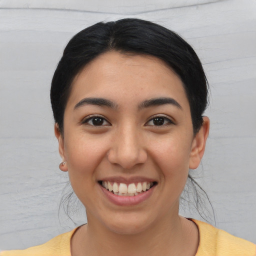 Joyful white young-adult female with short  black hair and brown eyes