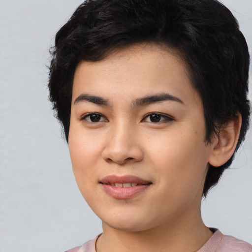 Joyful asian young-adult female with short  black hair and brown eyes