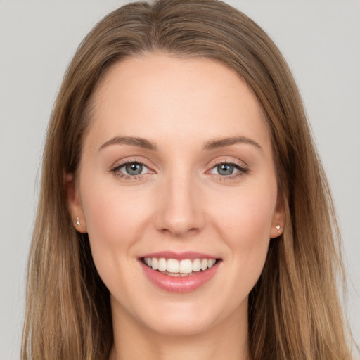 Joyful white young-adult female with long  brown hair and grey eyes