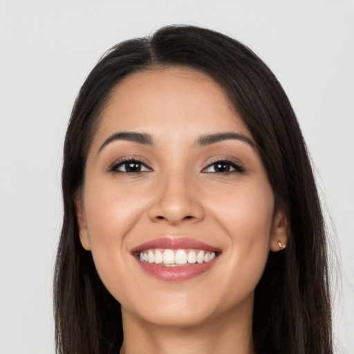 Joyful latino young-adult female with long  black hair and brown eyes